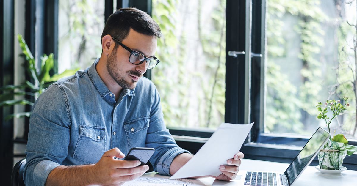 a man holding a paper